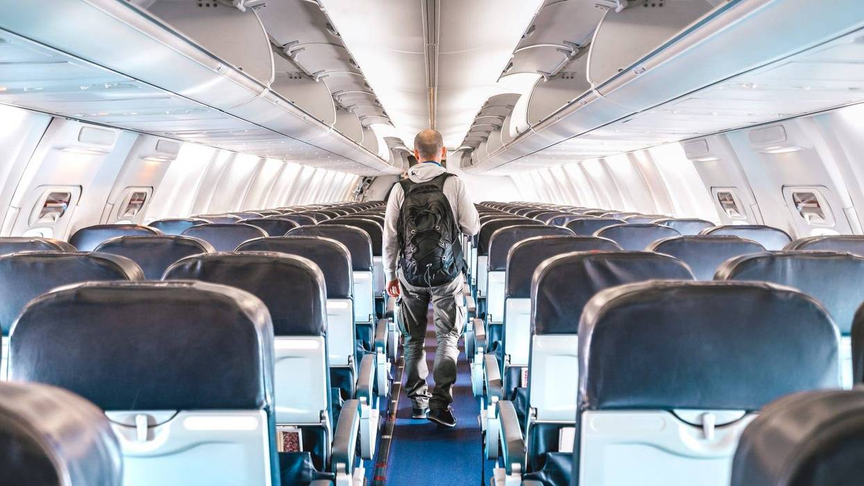 A man walks through an empty airplane