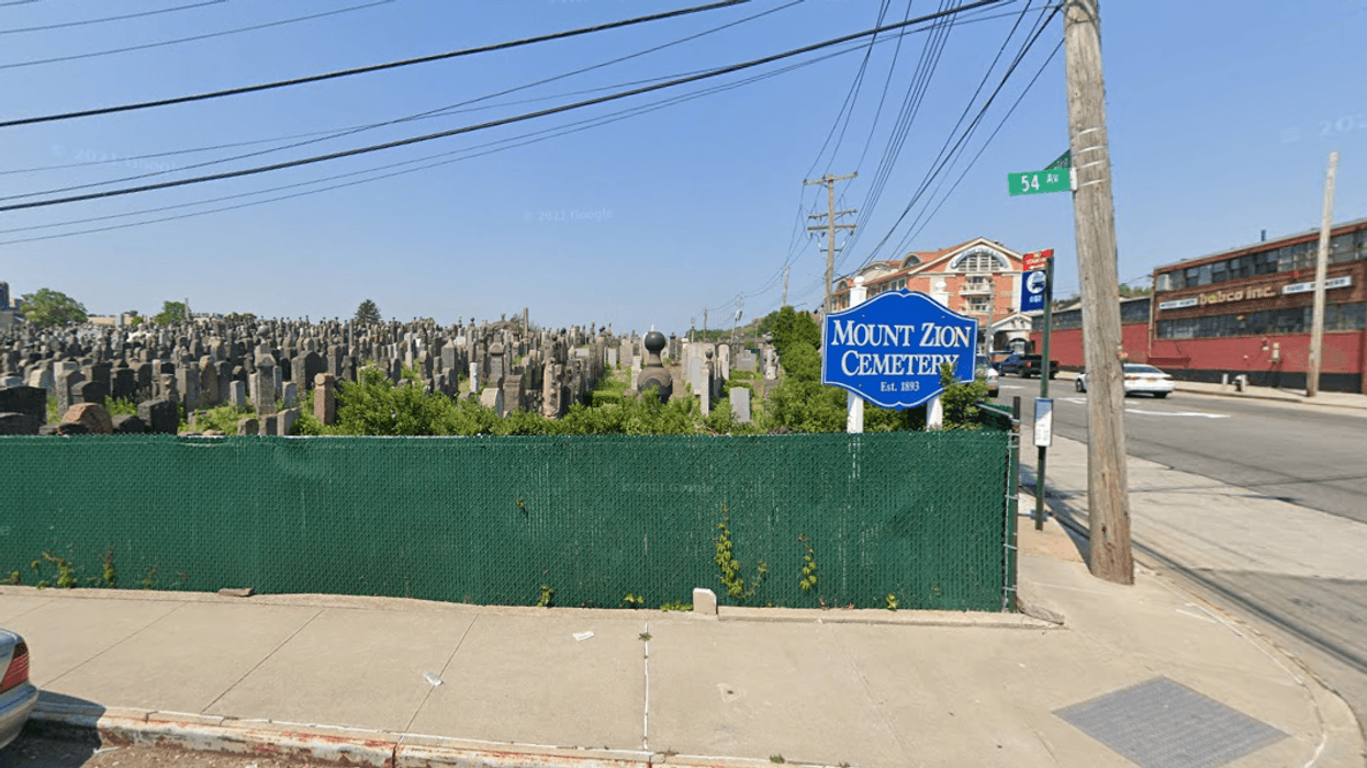 A man who was asleep under a van in Queens was killed Tuesday after the driver returned to the vehicle and inadvertently ran him over.