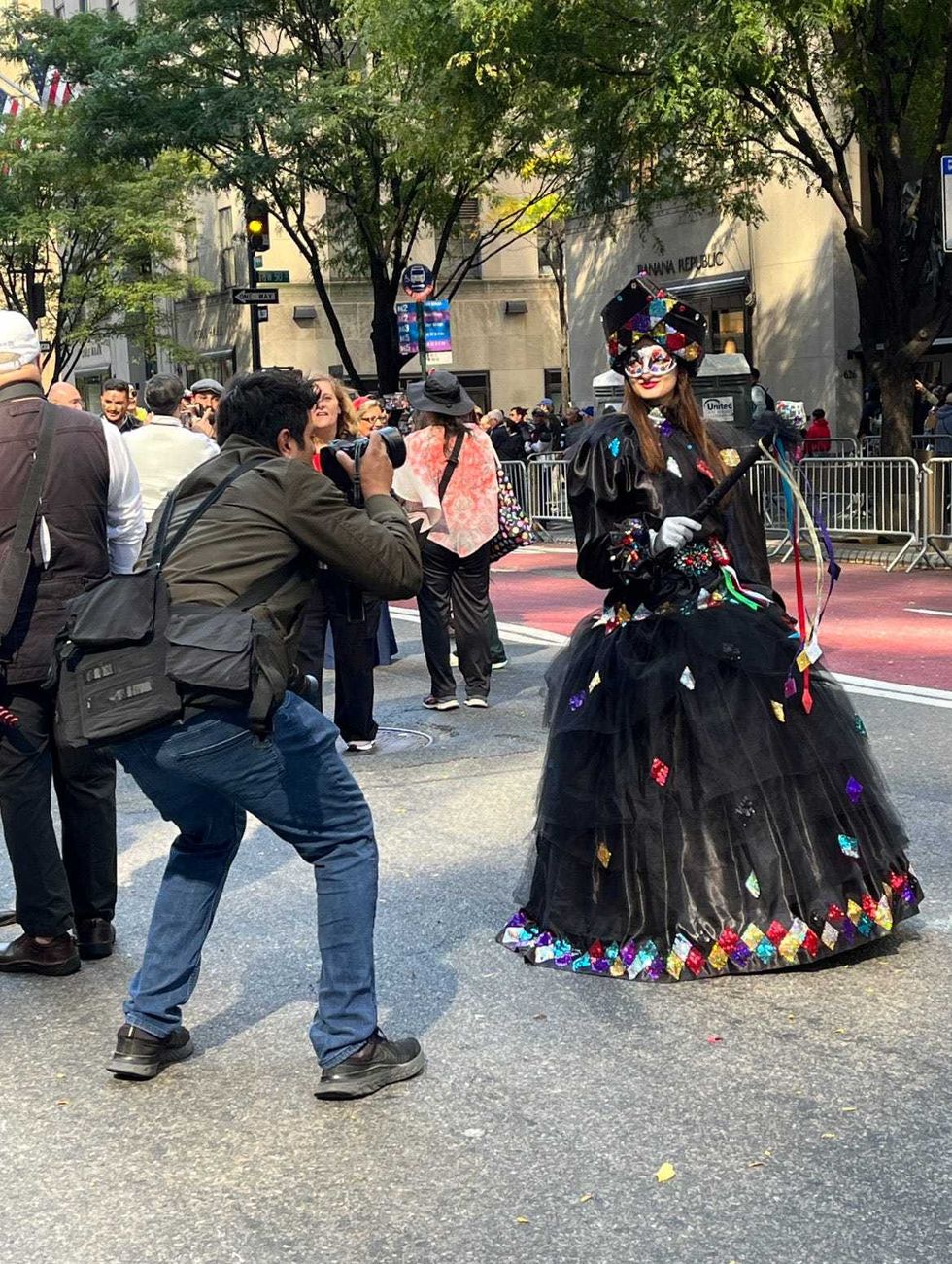A marcher poses for a photo along the parade route