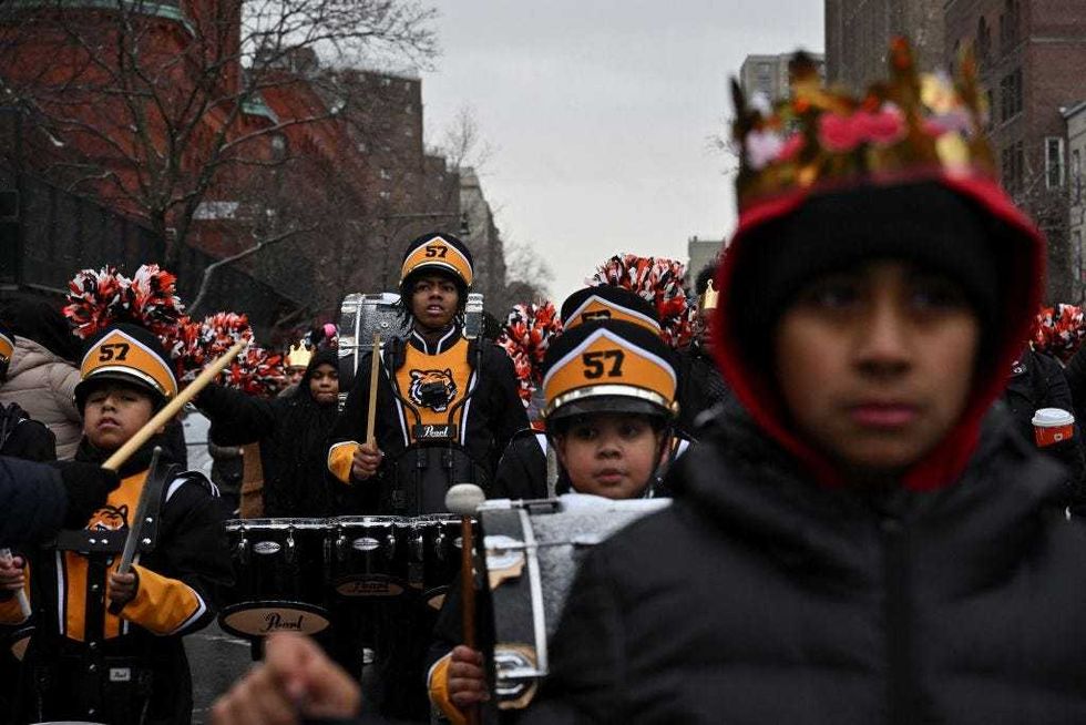 A marching band takes to the streets for the parade put on as part of El Museo del Barrio