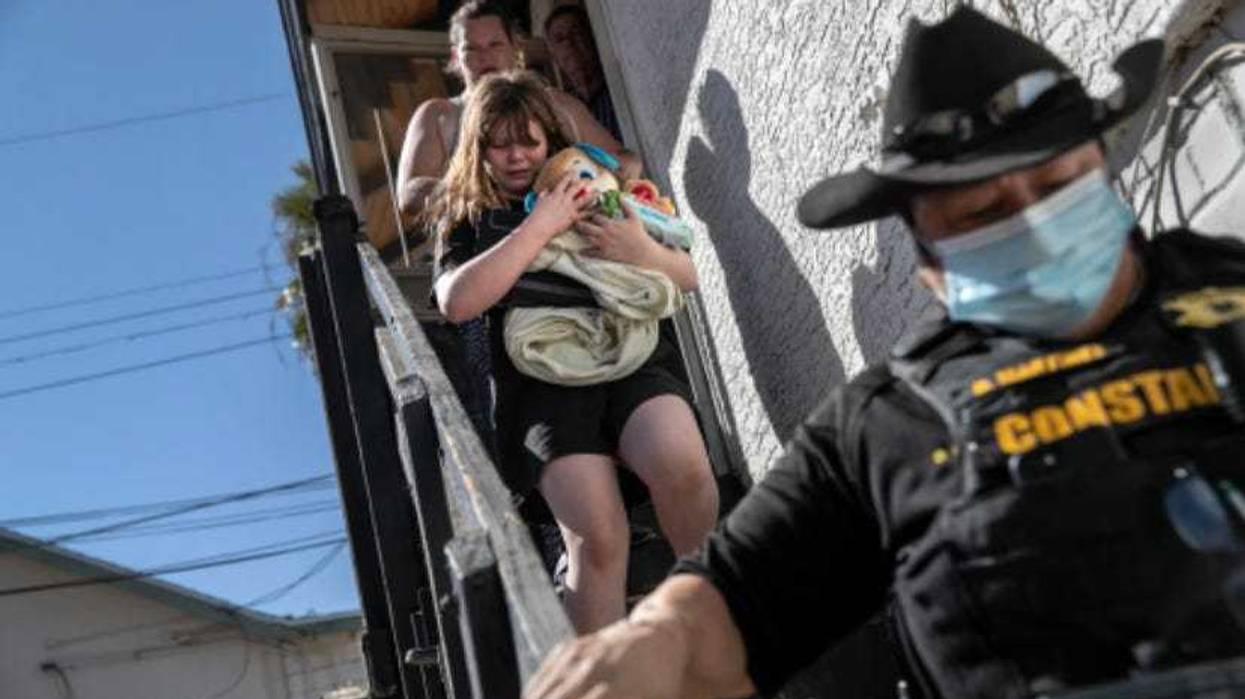 A Maricopa County constable escorts a family out of their apartment after serving an eviction order for non-payment.