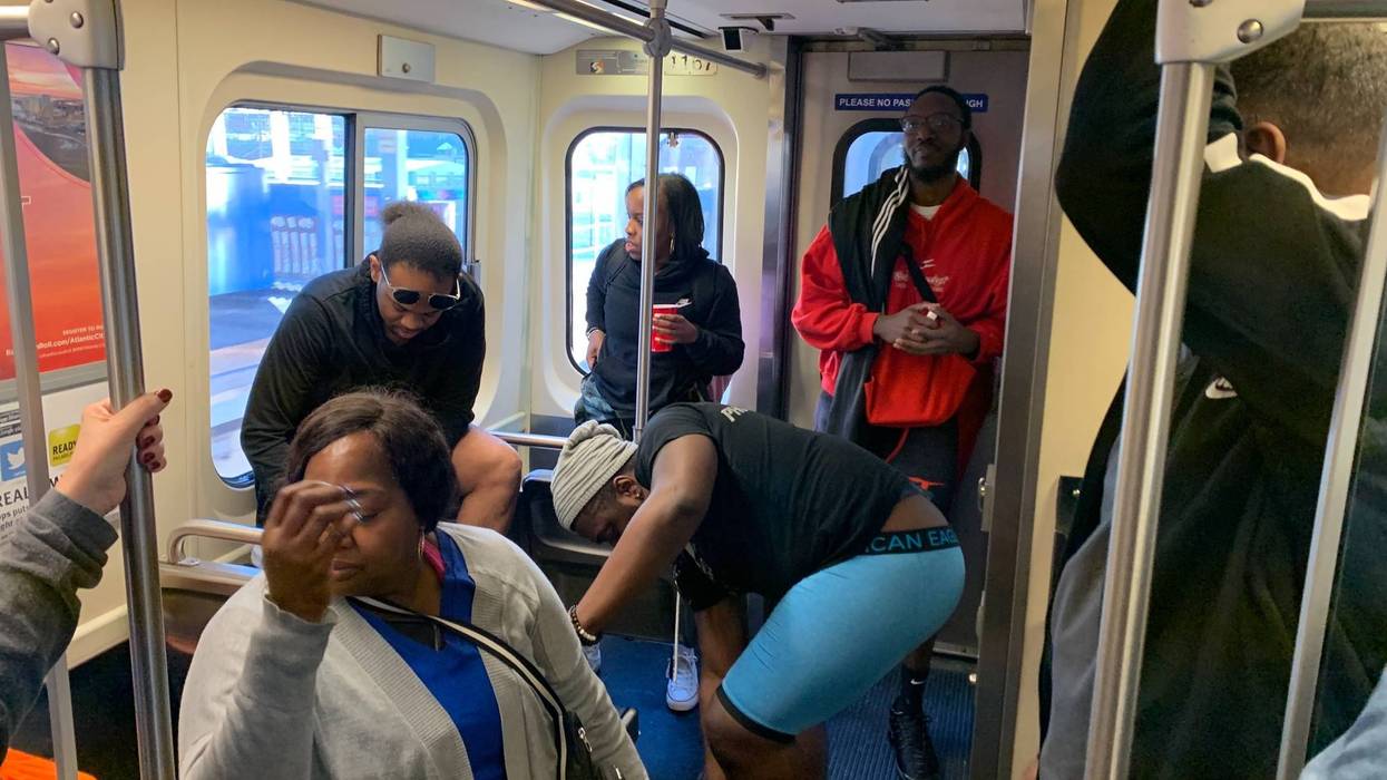 A Market-Frankford Line rider looks away as fellow passengers take part in the No Pants Subway Ride to benefit the homeless.