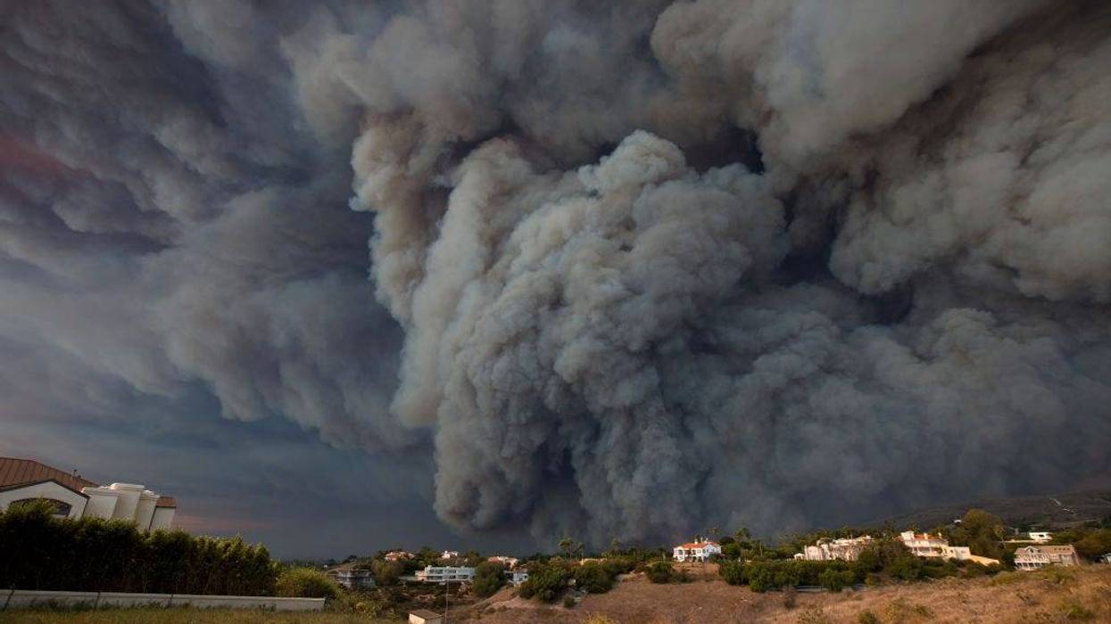 A massive smoke plume, powered by strong winds, rises above the the Woolsey Fire on November 9, 2018 in Malibu, California.