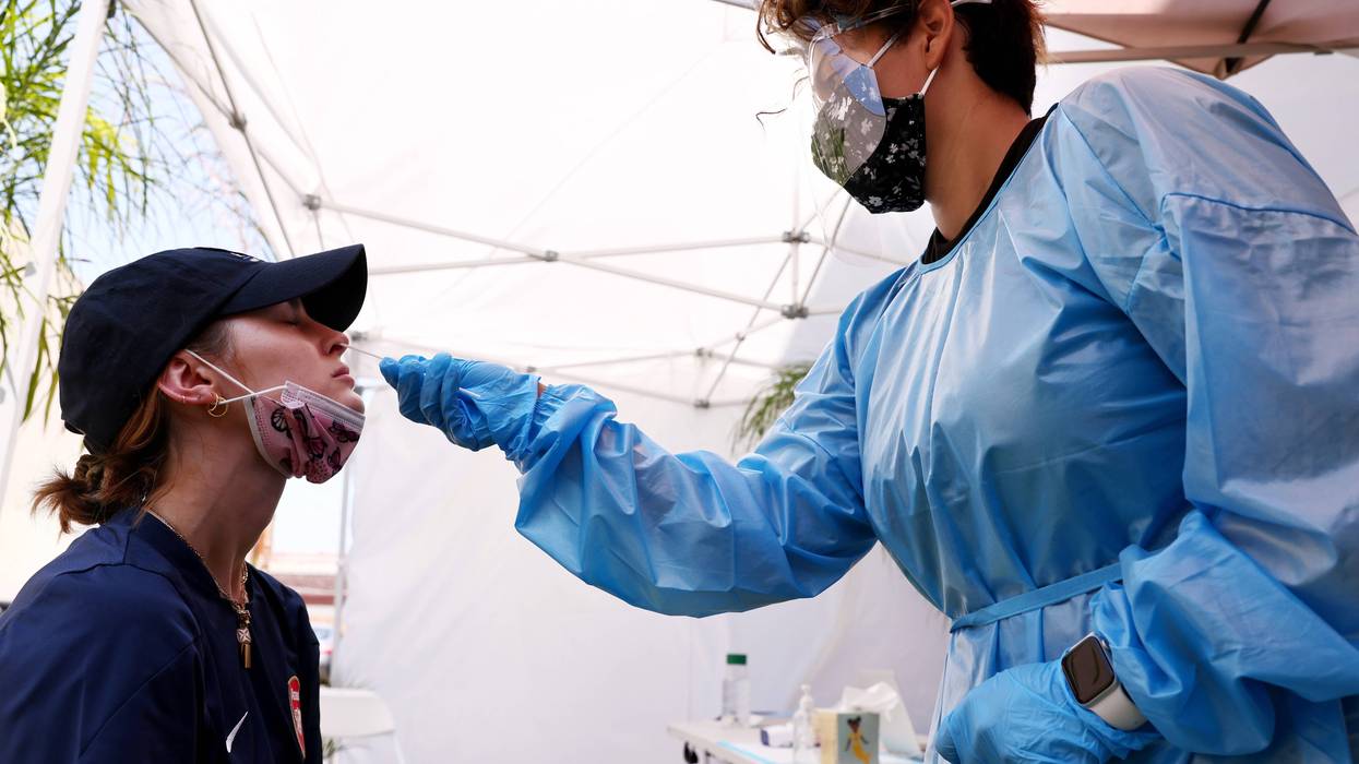 A medical assistant administers a COVID-19 test to a person at Sameday Testing on July 14, 2021 in Los Angeles, California.
