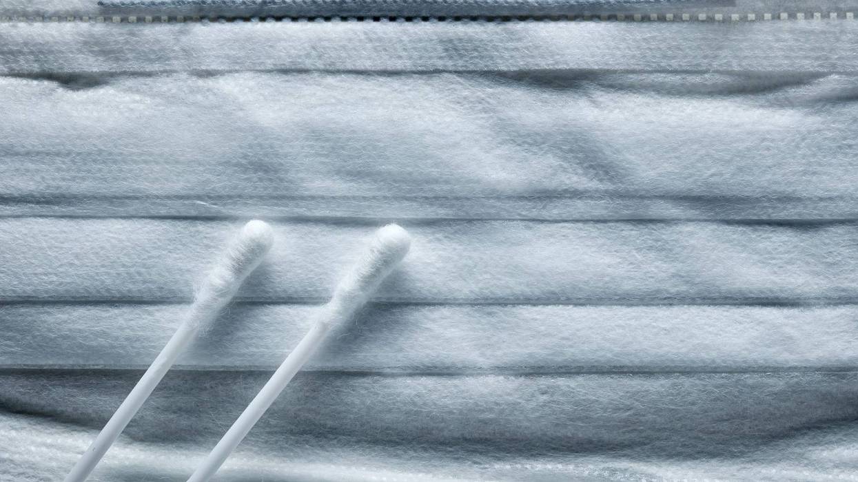 a medical mask and cotton swabs for a virus test