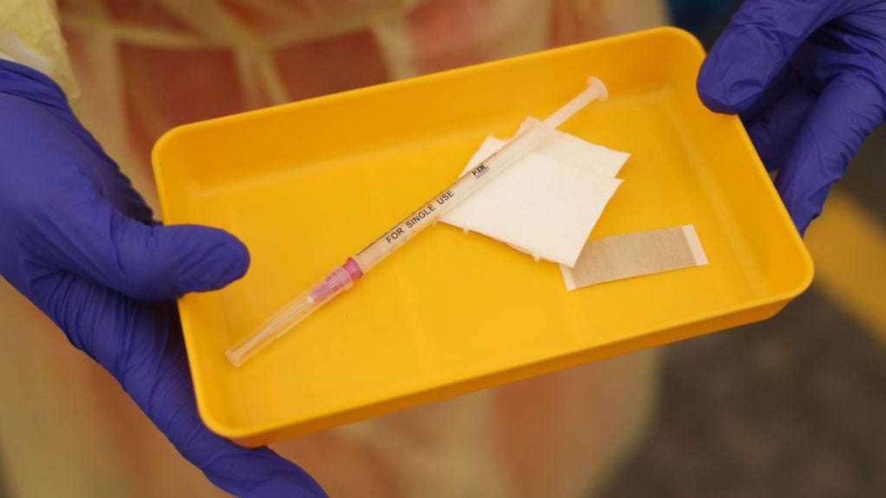 A medical worker holds a syringe of the Moderna vaccine against Covid-19 at a newly-opened drive-in vaccination center during the Omicron wave of the novel coronavirus pandemic on February 10, 2022 in Berlin, Germany.