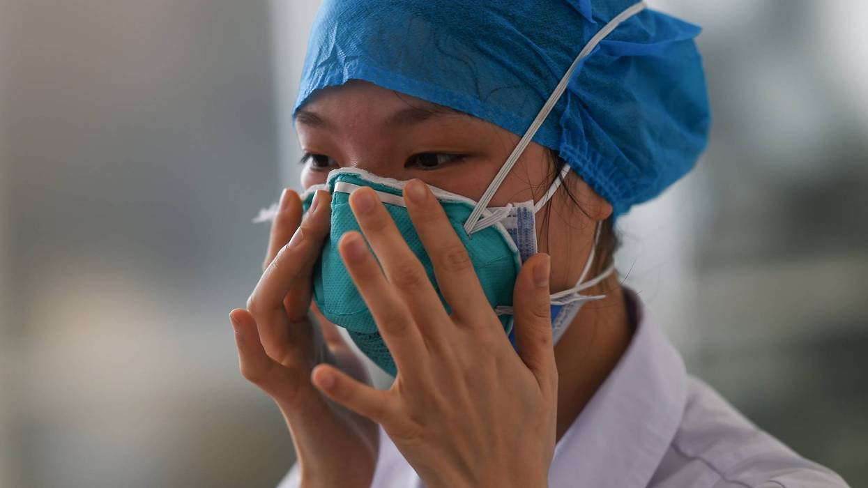 A medical worker learns how to wear masks during a medical training session at People's Hospital of Chengmai County, south China's Hainan province, Feb. 11, 2020.