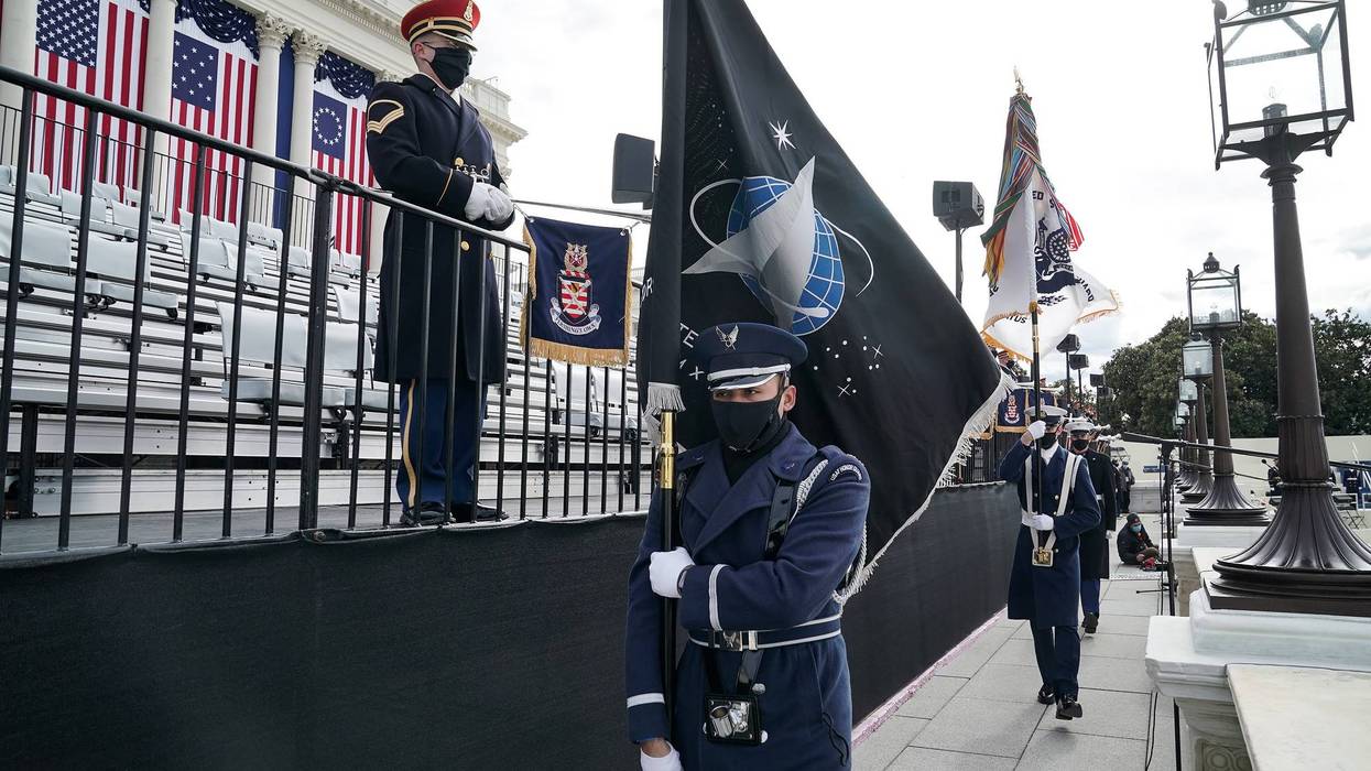 A member of the Air Force holds a Space Force flag in an honor guard during a dress rehearsal for the 59th inaugural ceremony for President-elect Joe Biden and Vice President-elect Kamala Harris at the U.S. Capitol on January 18, 2021 in Washington, DC.