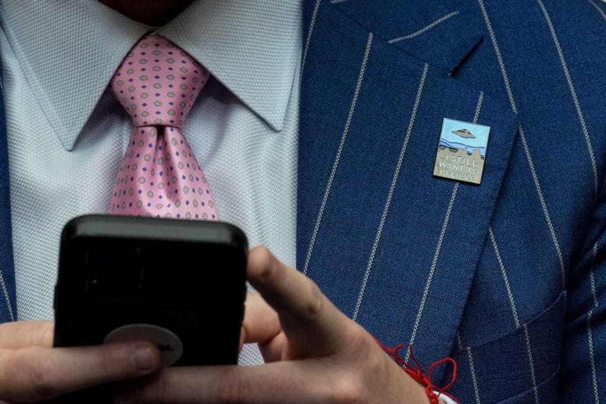 A member of the audience wears a pin that says "I Still Want To Believe" during a House Oversight Committee hearing titled "Unidentified Anomalous Phenomena: Implications on National Security, Public Safety, and Government Transparency" on Capitol Hill 26, 2023 in Washington, DC. Several witnesses are testifying about their experience with possible UFO encounters and discussion about a potential covert government program concerning debris from crashed, non-human origin spacecraft. (Photo by Drew Angerer/Getty Images)