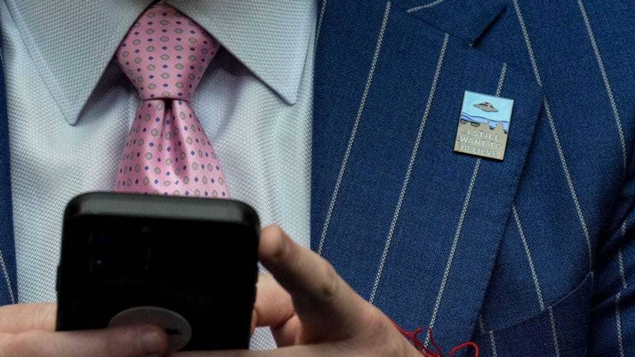 A member of the audience wears a pin that says "I Still Want To Believe" during a House Oversight Committee hearing titled "Unidentified Anomalous Phenomena: Implications on National Security, Public Safety, and Government Transparency" on Capitol Hill 26, 2023 in Washington, DC. Several witnesses are testifying about their experience with possible UFO encounters and discussion about a potential covert government program concerning debris from crashed, non-human origin spacecraft. (Photo by Drew Angerer/Getty Images)