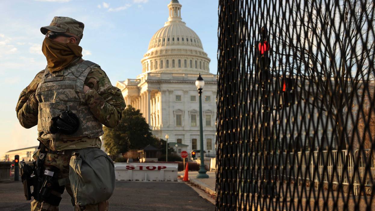 A member of the New York National Guard stands at a gate outside the U.S. Capitol the day after the House of Representatives voted to impeach President Donald Trump for the second time January 14, 2021 in Washington, DC.