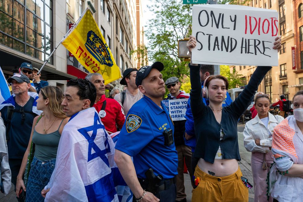 A member of the NYPD speaks with supporters of Israel during demonstrations outside The New School in lower Manhattan as tensions over the war in Gaza continue on campuses and inside of colleges and universities throughout the city on May 02, 2024 in New York City