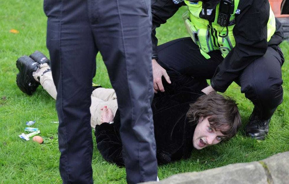 A member of the public is arrested by Police after throwing eggs at King Charles III and Camilla, Queen Consort as they arrive for the Welcoming Ceremony to the City of York at Micklegate Bar during an official visit to Yorkshire on November 09, 2022 in York, England. (Photo by Chris Jackson/Getty Images)