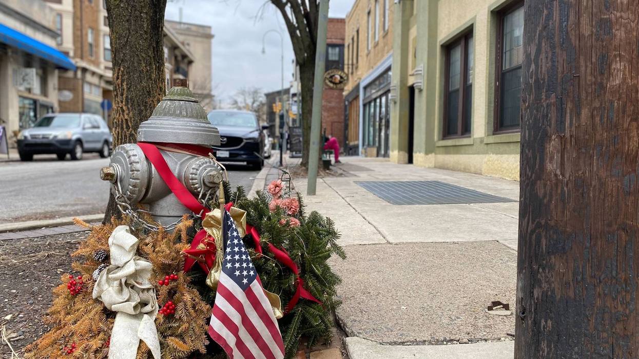 A memorial is set up near the location where 70-year-old Renee DiPietro is accused of murdering 31-year-old Michael Sides.