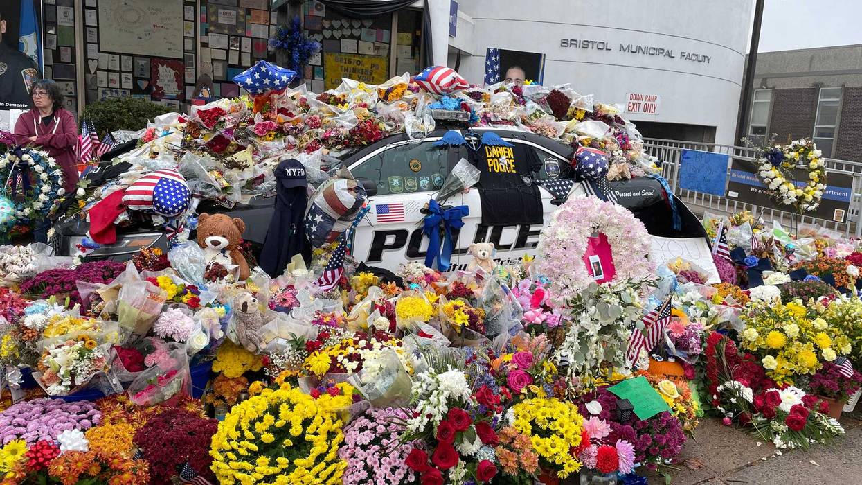 A memorial outside the Bristol Police Dept. for Lt. Dustin DeMonte and Sgt. Alex Hamzy, killed two weeks ago. Photo: 10/26/22