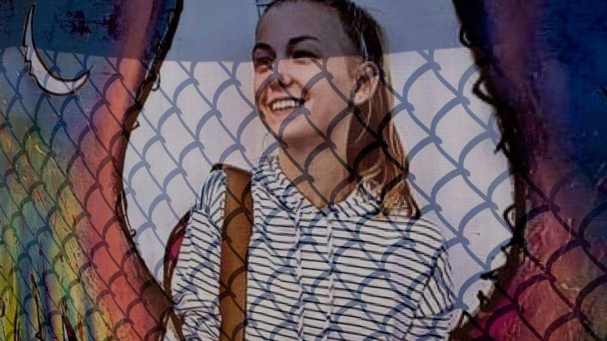 A memorial poster of Gabby Petito hangs on a fence across the street from the funeral home where the memorial service for the murdered woman is being held, September 26, 2021 in Holbrook, Long Island, New York.