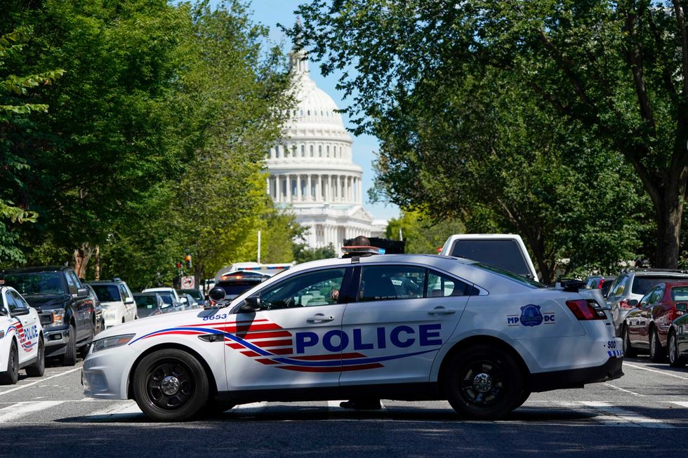 A Metropolitan Police Department cruiser blocks a street near the U.S. Capitol and a Library of Congress building in Washington on Thursday, Aug. 19, 2021, as law enforcement officials investigate a report of a pickup truck containing an explosive device