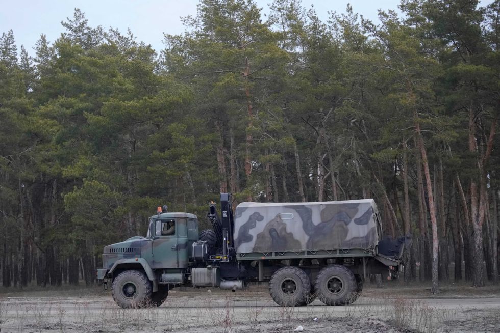 A military vehicle stands by the side of the road in Sievierodonetsk, the Luhansk region, eastern Ukraine, Thursday, Feb. 24, 2022