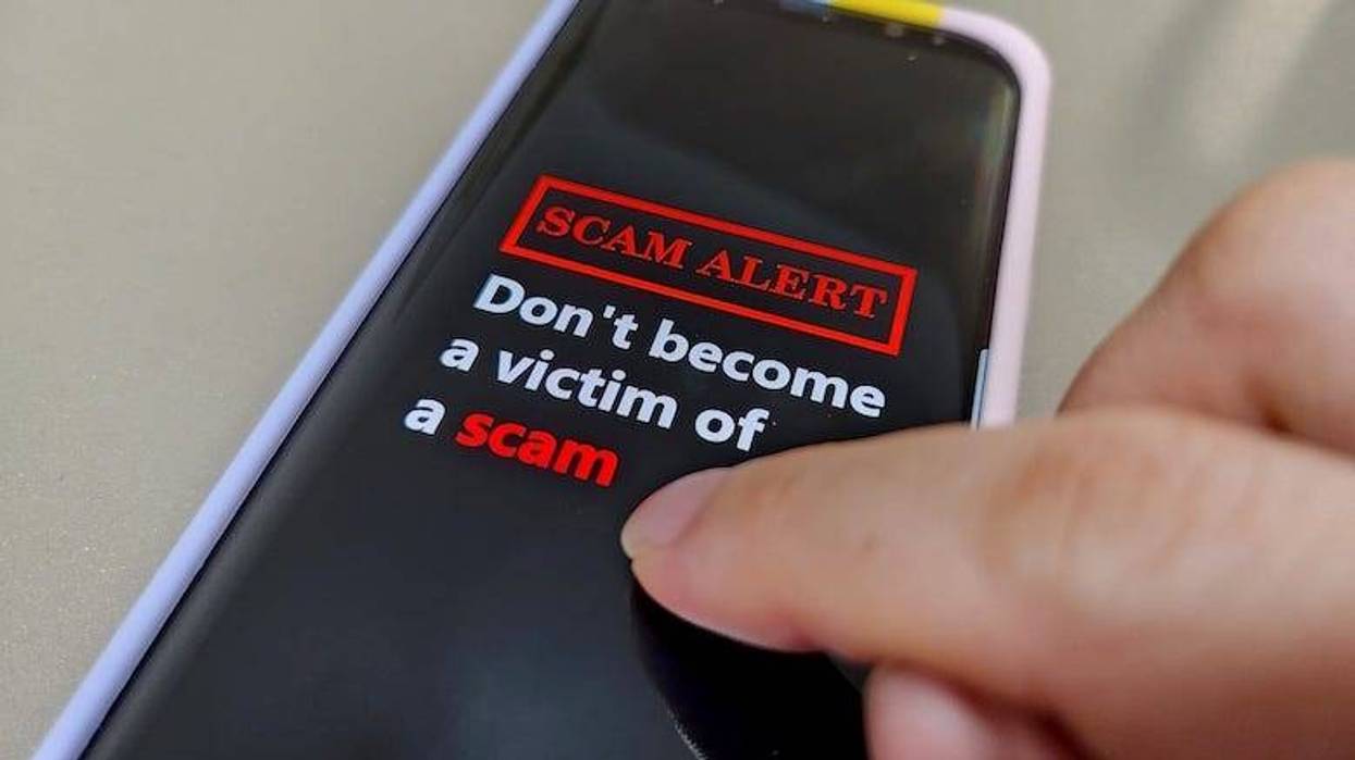 A mobile phone showing the message Don't Become A Victim Of A Scam