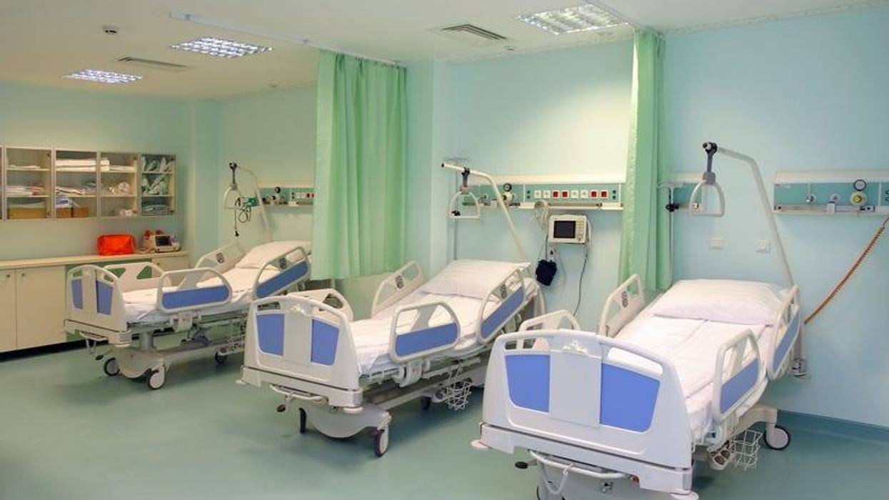 A modern hospital saloon with beds.
