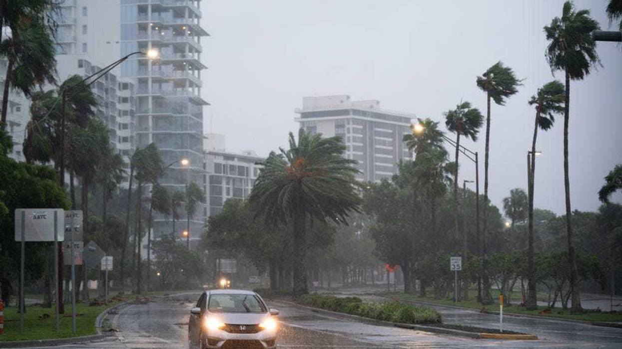 A motorist travels near the Sarasota Bay waterfront as Hurricane Ian approaches on September 28, 2022 in Sarasota, Florida.