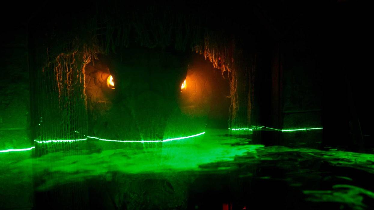 A movable Crocodile sits in a cave as fog hits lasers to look like water in a room at The Slaughterhouse, a 20,000 square foot haunted house in Downtown Des Moines on Friday, Sept. 4, 2020 in Des Moines. The attraction opens on October 2 with timed entrie