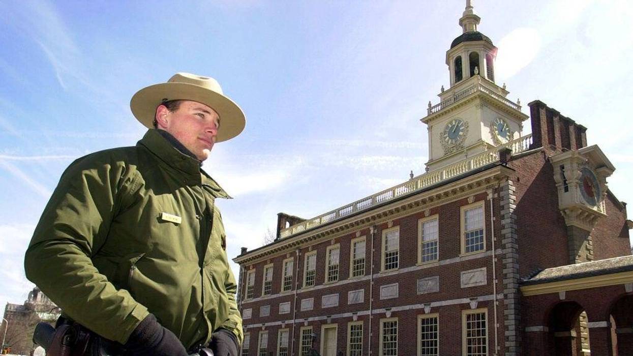 A national park ranger stands guard at Independence Hall.