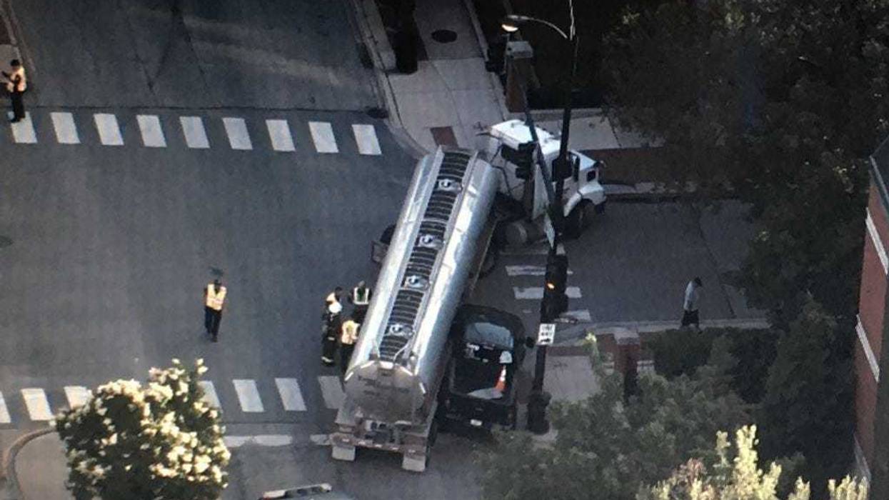 A Near West Side intersection has been shut down as crews work to clean up a fuel spill after a crash involving a semi tanker.