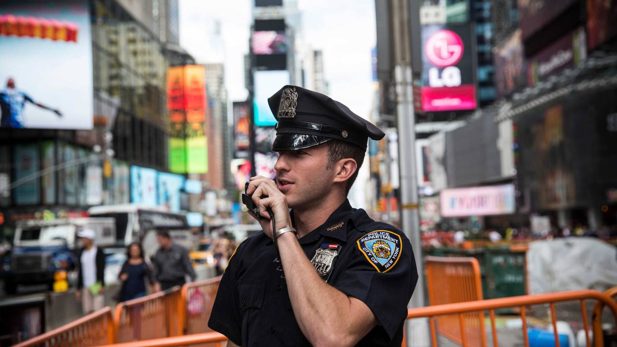 A New York Police Department (NYPD) officer speaks on his radio in Times Square in New York City.