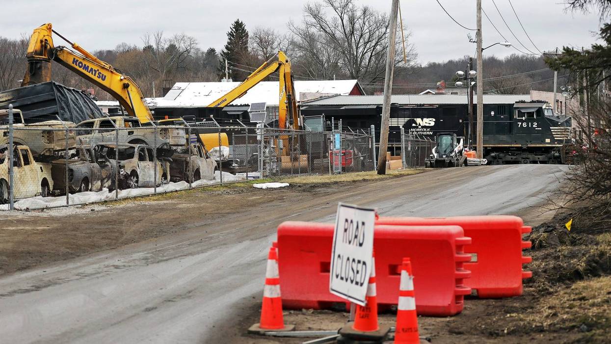 A Norfolk Southern train speeds through East Palestine as crews work to clean up wreckage from the Feb. 3 train derailment