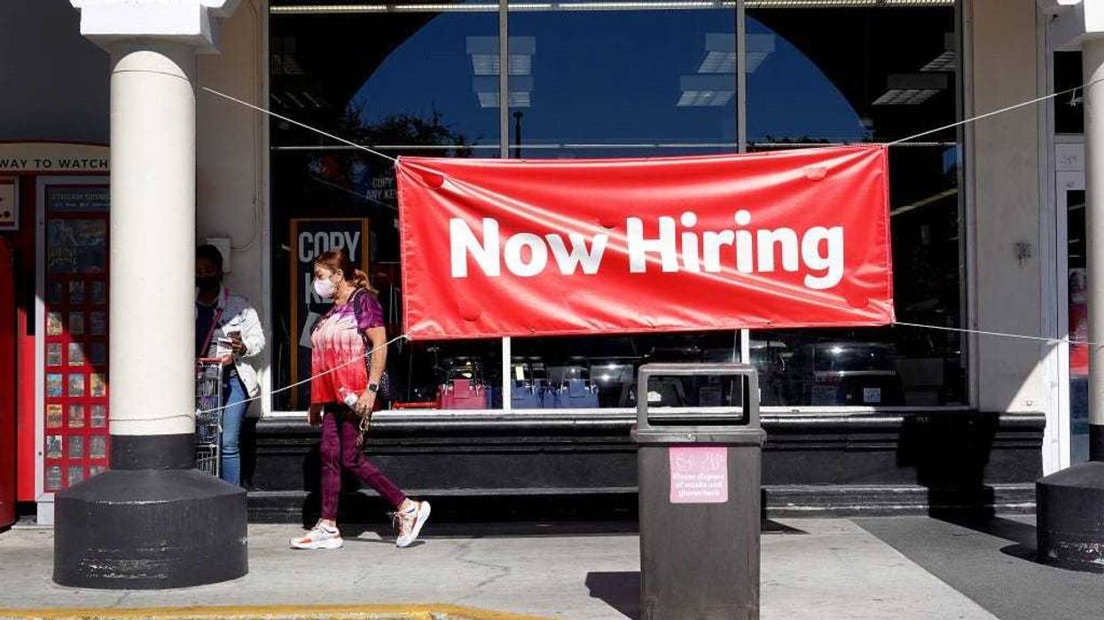A Now Hiring sign hangs in front of a Winn-Dixie grocery store on December 03, 2021 in Miami, Florida.