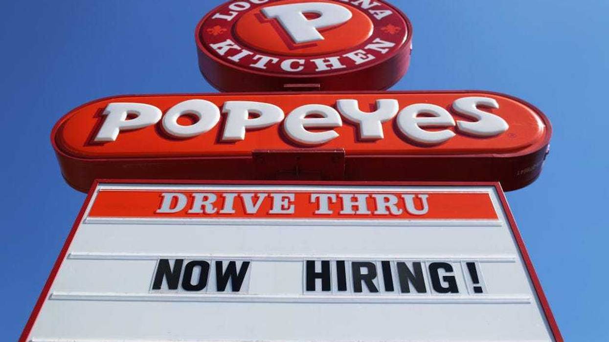 A 'Now Hiring' sign is posted in front of a Popeye's restaurant on February 04, 2021 in Miami, Florida.