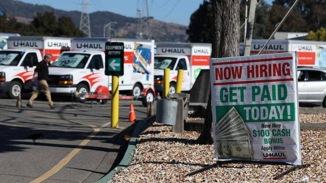 A now hiring sign is posted in front of a U-Haul rental center on November 03, 2023 in San Rafael, California.