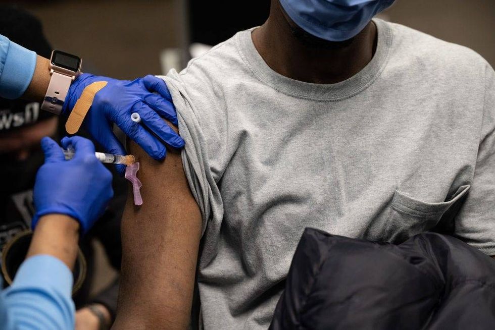 A nurse administers a Johnson & Jonson COVID-19 vaccination to a houseless person at Wayside Christian Mission on March 15, 2021 in Louisville, Kentucky.
