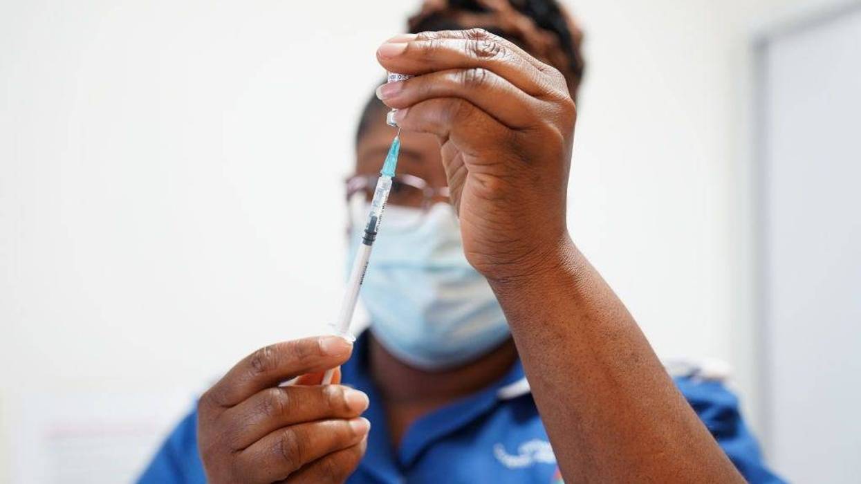 A nurse prepares a dose of a Covid-19 vaccine for Margaret Keenan, 91, prior to her receiving a spring Covid-19 booster shot at University Hospital Coventry on April 22, 2022 in Coventry, England.