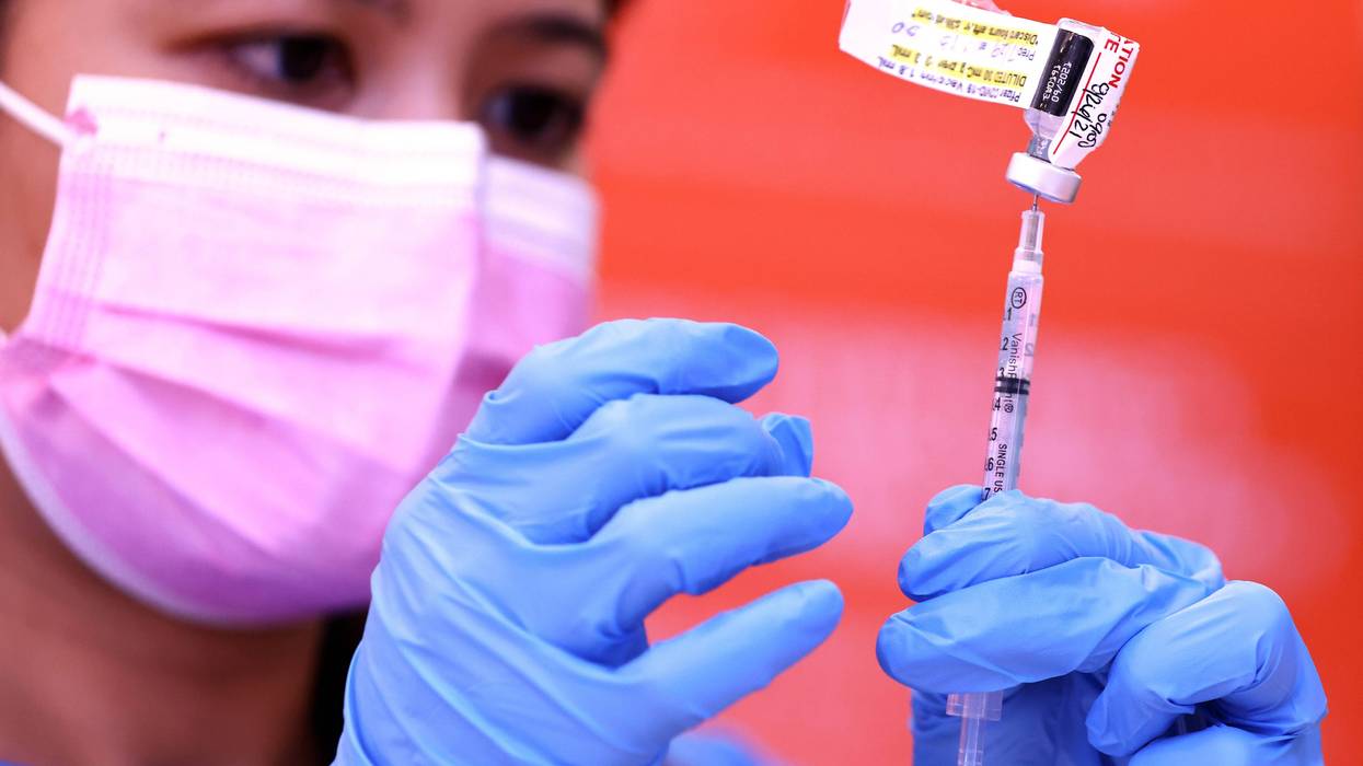A nurse prepares a dose of the Pfizer COVID-19 vaccine.