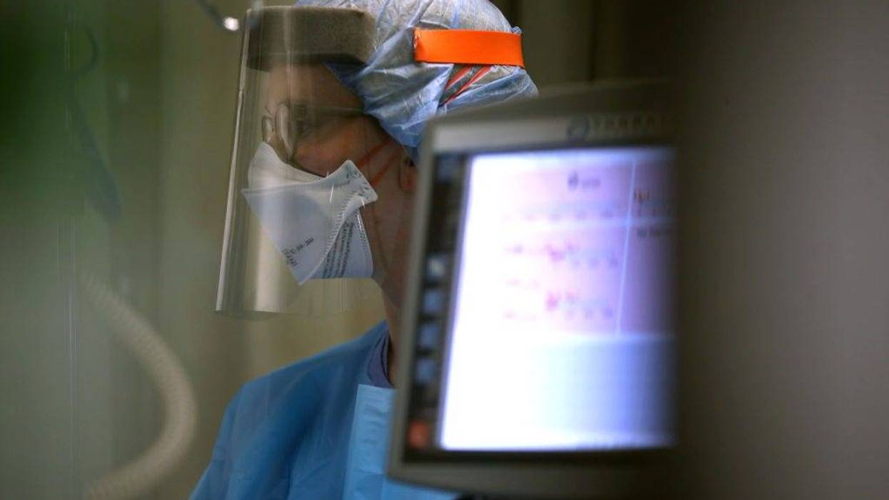 A nurse wears personal protective equipment (PPE)