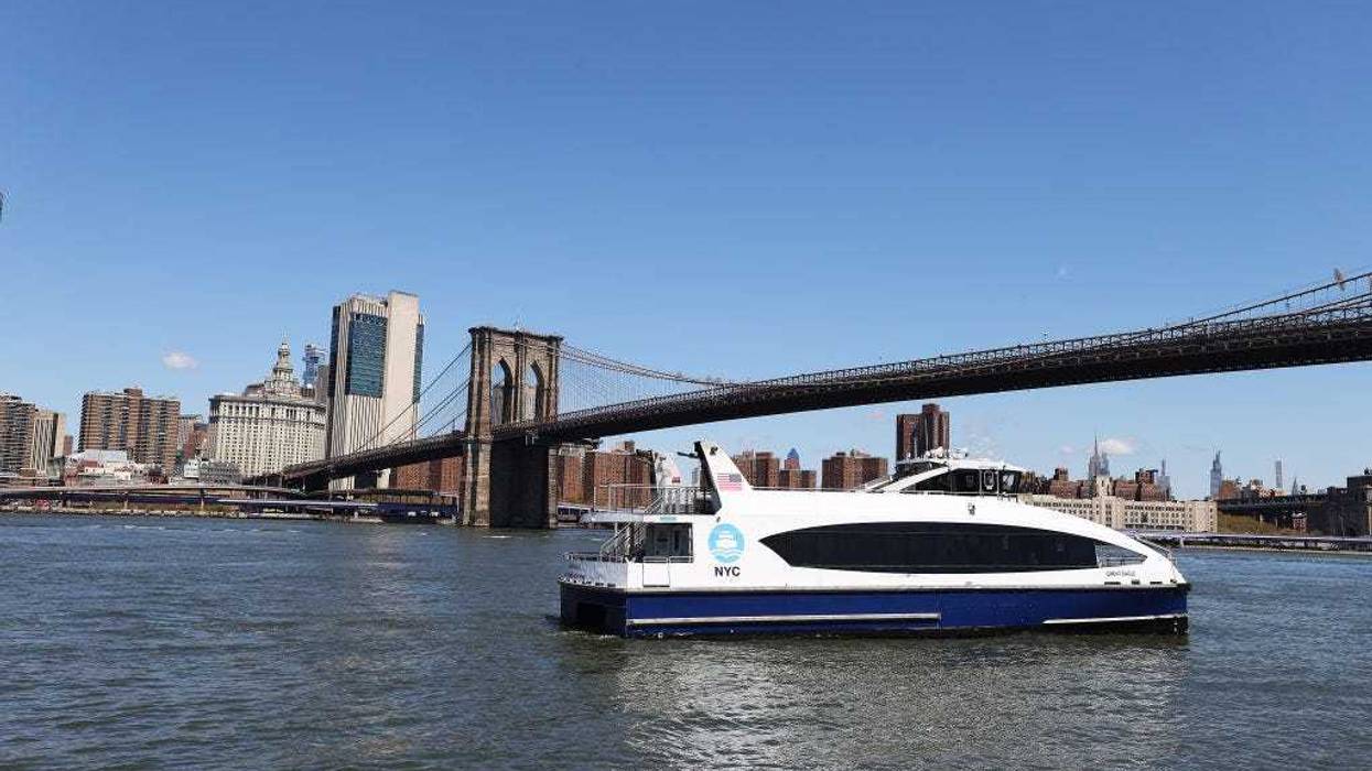 A NYC Ferry crosses the East River at Brooklyn Bridge Park on April 28, 2020