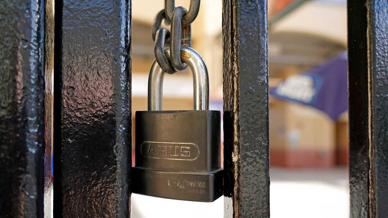 A padlock is seen on the gate of the entrance of Roger Dean Chevrolet Stadium. Major League Baseball has suspended the rest of its spring training schedule due to the Covid 19 coronavirus outbreak.