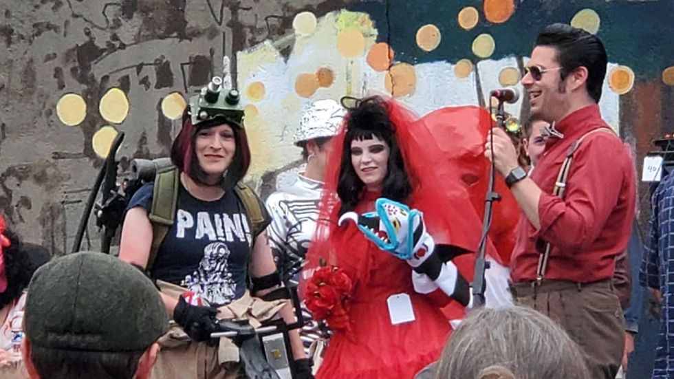 A pair of cosplayers dressed as a Ghostbuster (left) and Lydia Deetz from "Beetlejuice" enter the costume contest at Blobfest.