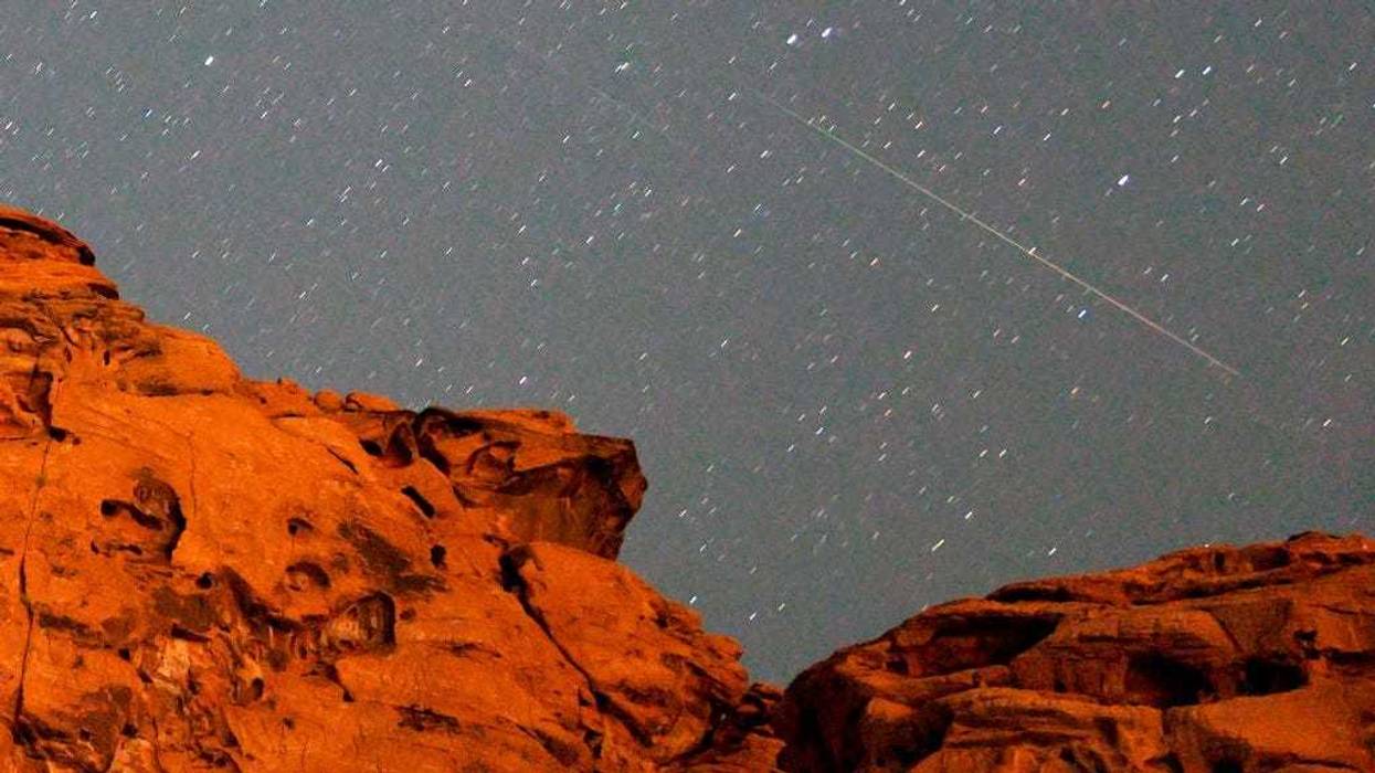A pair of Perseid meteors streak over a sandstone outcropping at Redstone in the Pinto Valley wilderness area on August 12, 2021 in the Lake Mead National Recreation Area, Nevada.