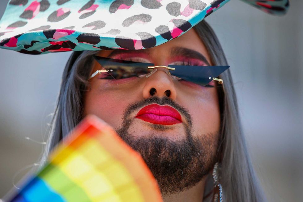 A participant pauses in the annual Pride Parade, in Tel Aviv, Israel, Friday, June 25, 2021. Thousands of people attended the parade Friday in one of the largest public gatherings held in Israel since the onset of the coronavirus pandemic.