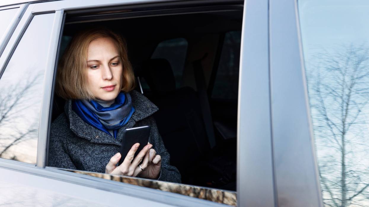 A passenger in a car summoned by an app.