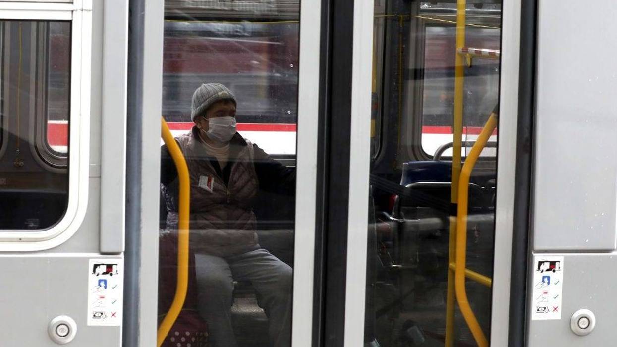A passenger wears a protective mask while riding a San Francisco MUNI bus during the coronavirus (COVID-19) pandemic on April 06, 2020 in San Francisco, California.