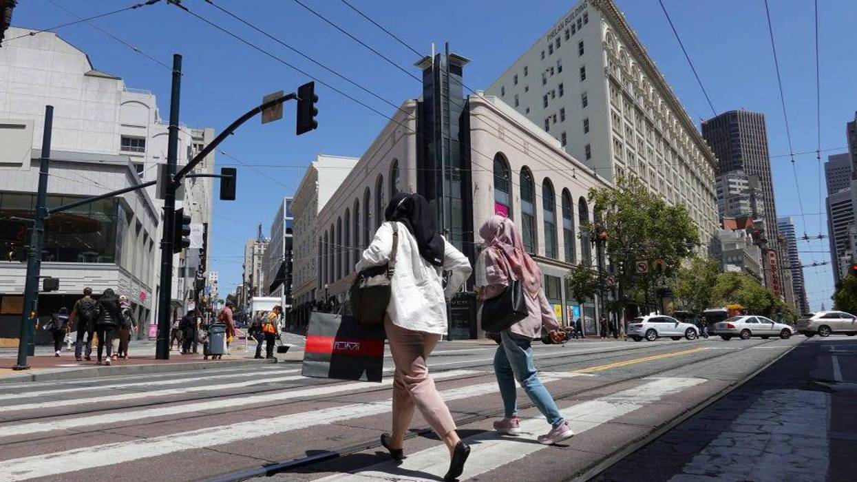 A pedestrian carries a shopping bagwhile walking through Union Square on May 17, 2022 in San Francisco, California.