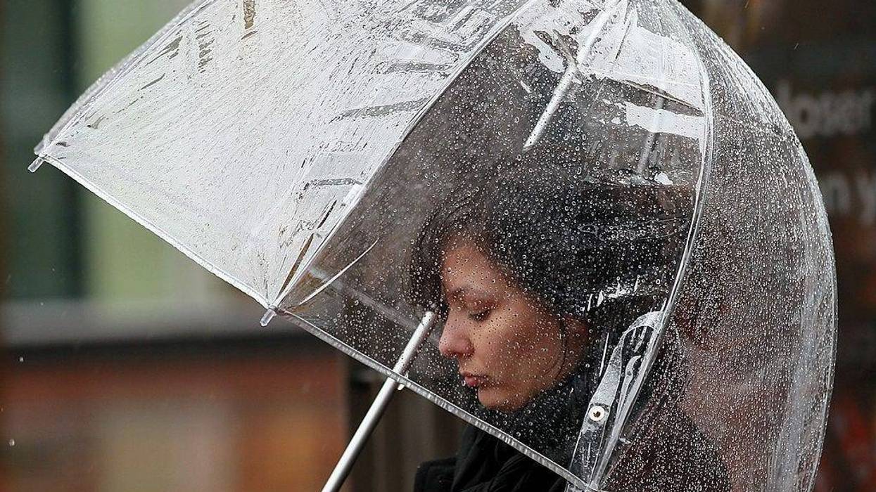 A pedestrian carries an umbrella as she walks down Market Street on February 17, 2011 in San Francisco, California.