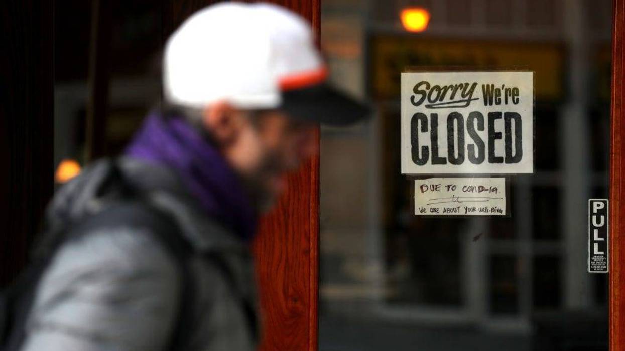 A pedestrian walks by a closed sign on the door of a restaurant on March 17, 2020 in San Francisco, California.