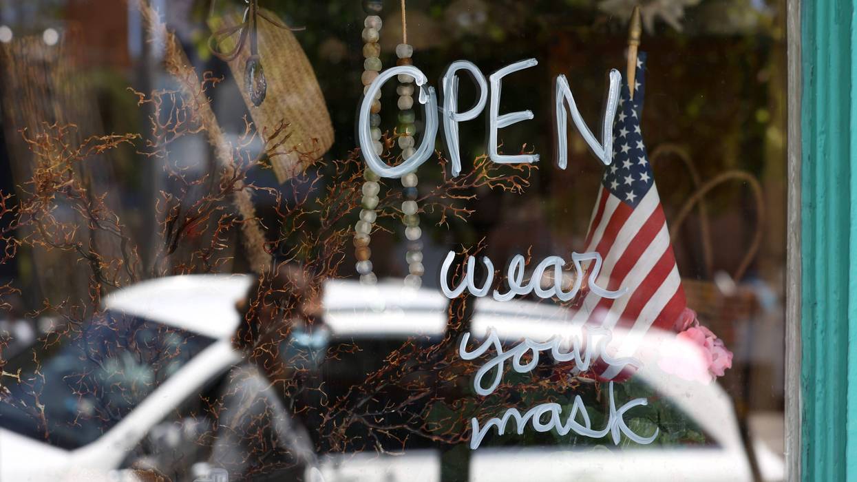 A pedestrian walks by a retail store that has reopened on June 16, 2020 in San Francisco, California.