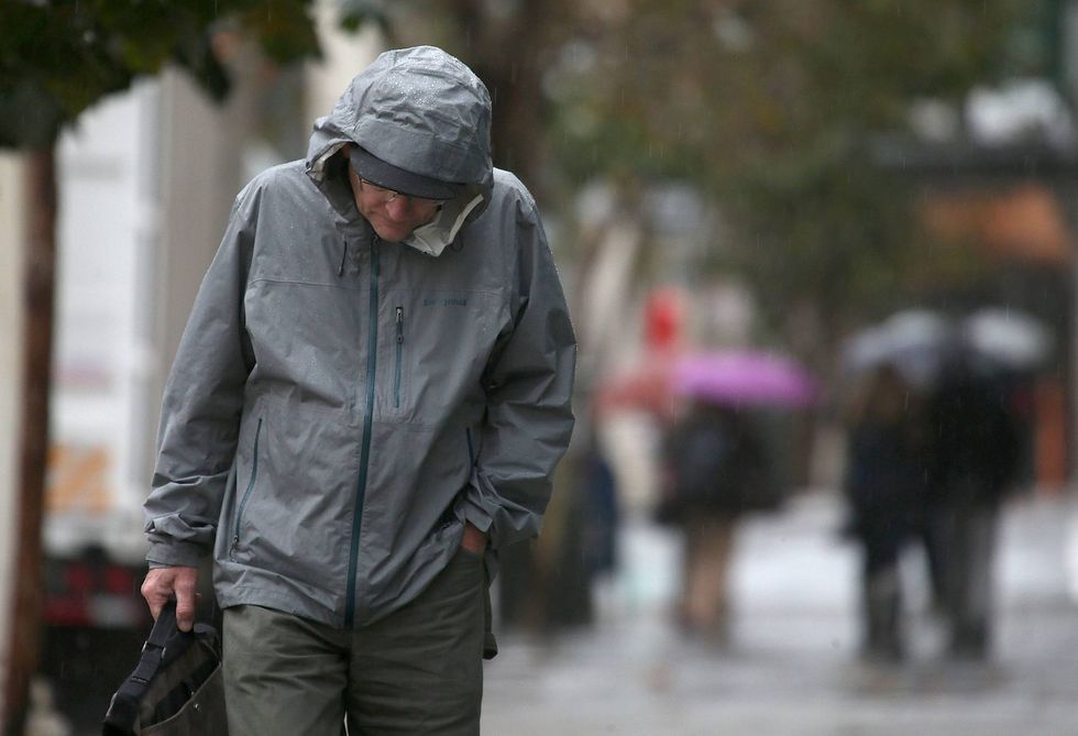 A pedestrian walks in the rain on December 11, 2014 in San Francisco, California.