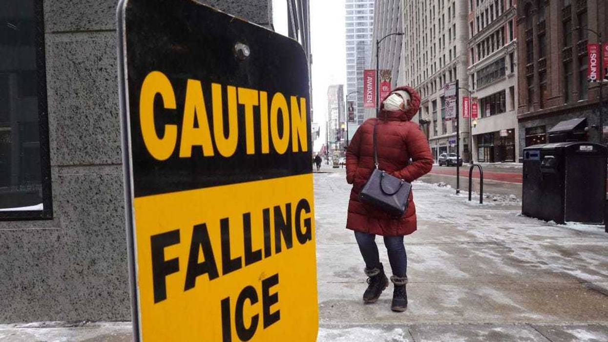 A pedestrian walks through downtown as temperatures hover in the negative single-digits on December 23, 2022 in Chicago, Illinois. Sub-zero temperatures are expected to grip the city for the next couple of days with wind chill temperature dipping as low as -40 degrees. (Photo by Scott Olson/Getty Images)